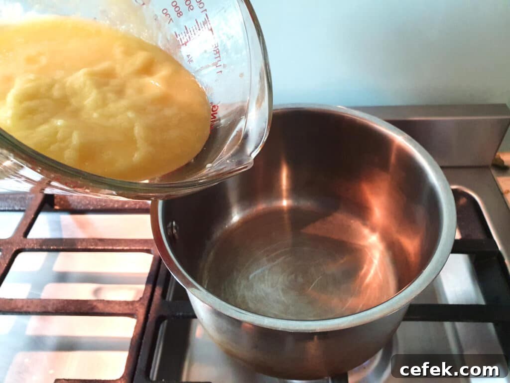 Adding blended pineapple to pot to reduce.