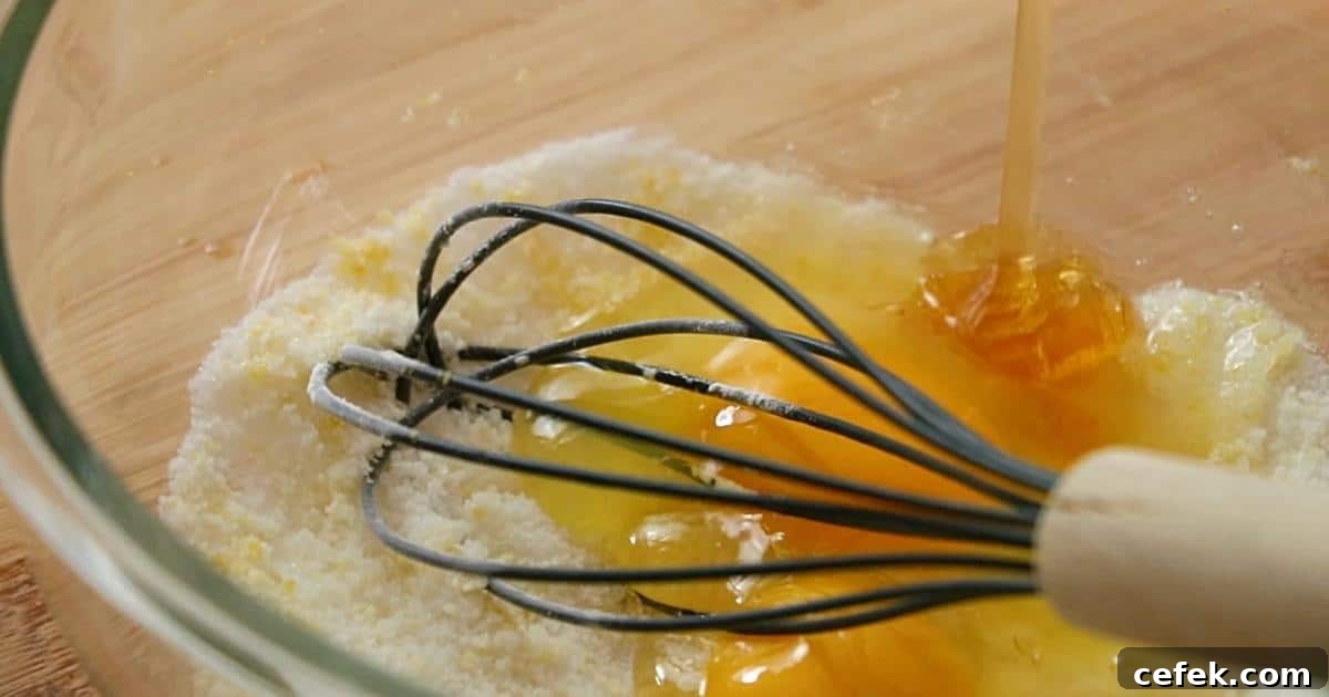 adding eggs and honey in sugar