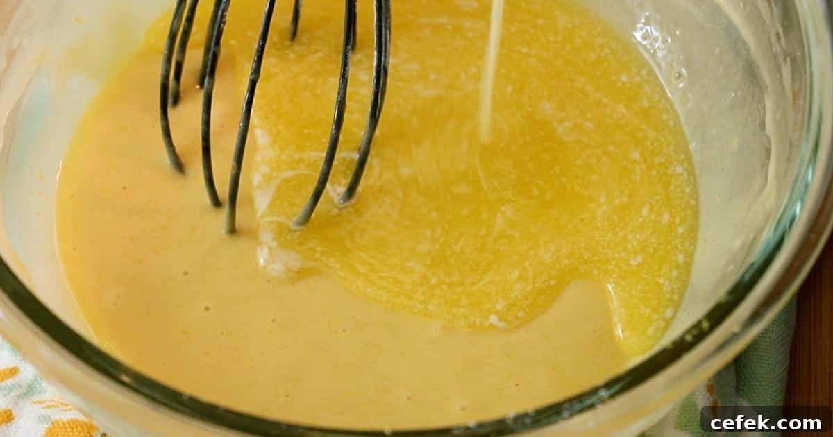 adding butter to the batter to make madeleines