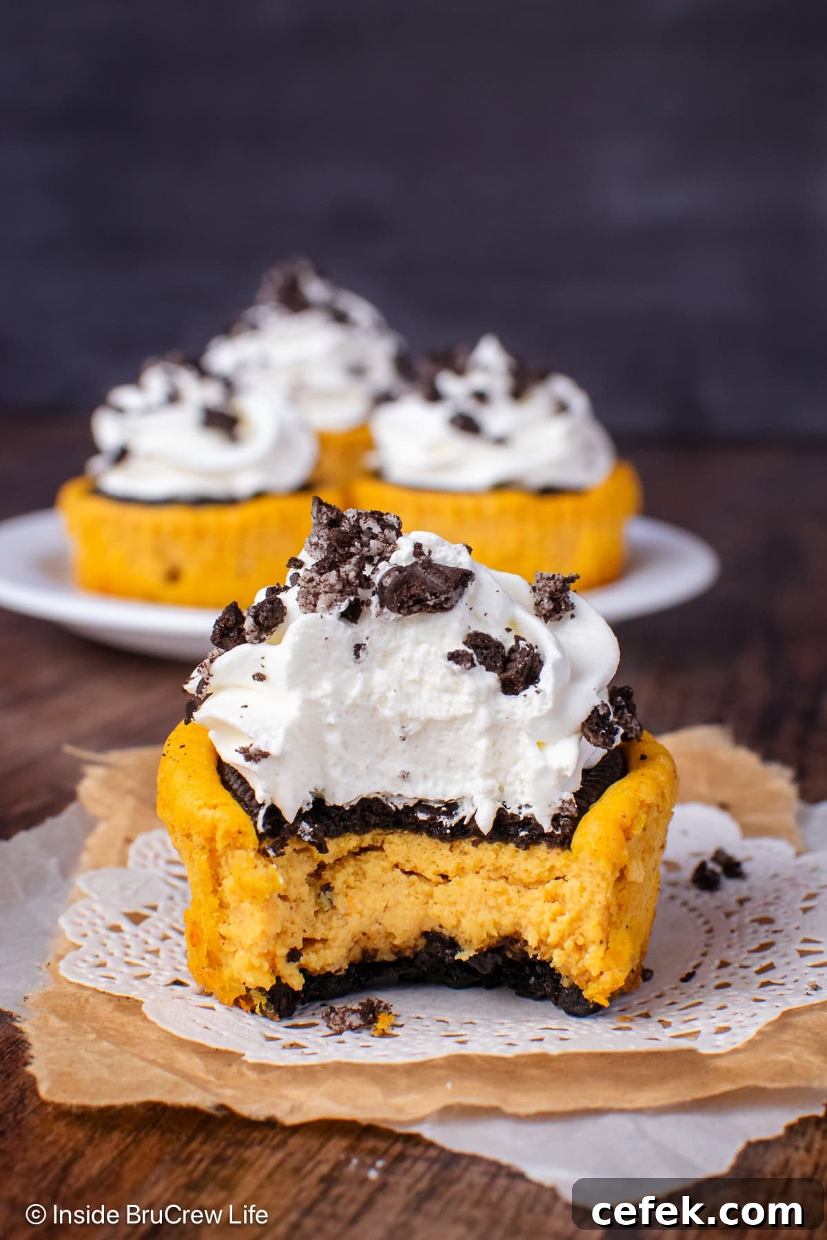 A mini pumpkin cheesecake with a bite out of it.