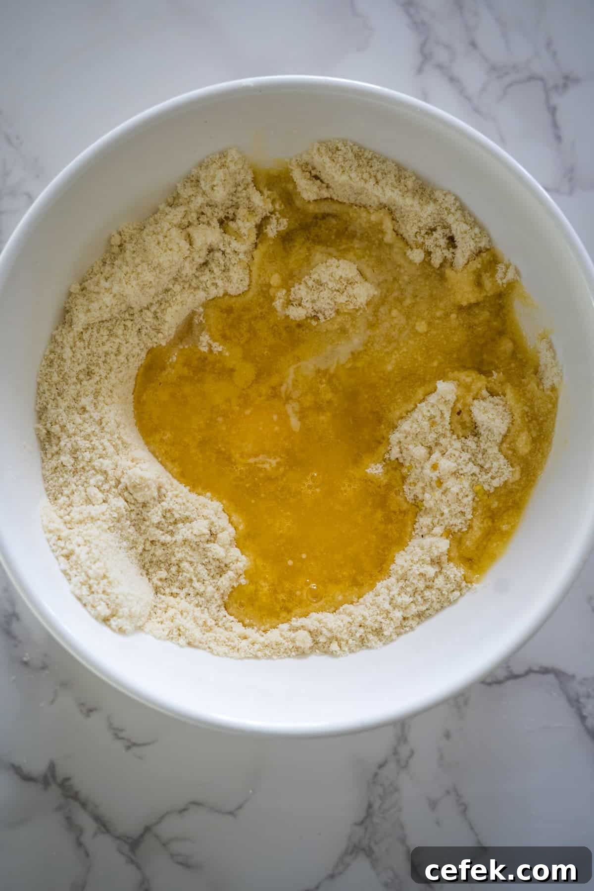 A white bowl with ingredients in it.
