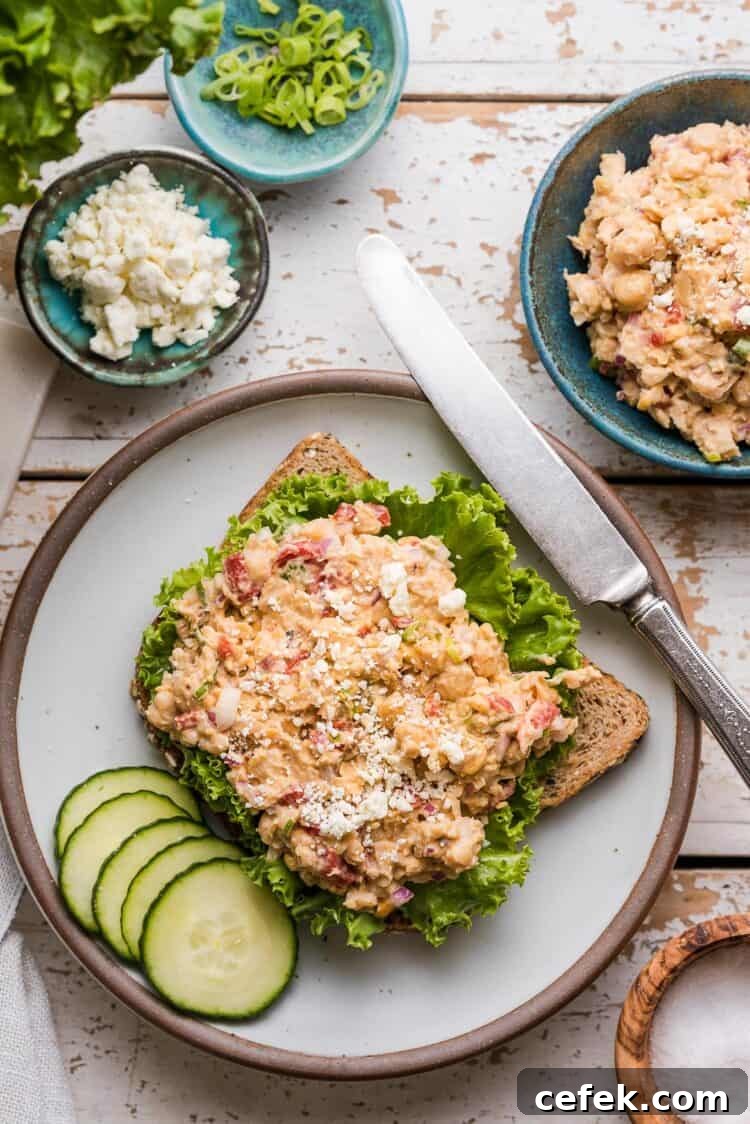 Chickpea Salad Sandwich with Feta on whole wheat bread on a plate.