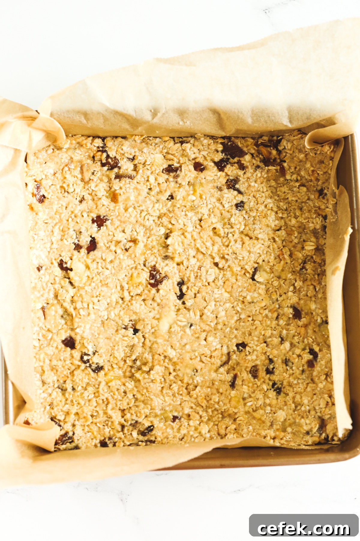 pan with pressed down oat mixture ready to bake