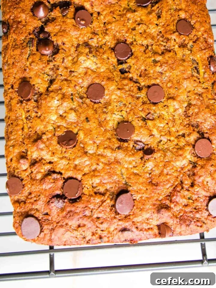 Chocolate Chip Zucchini Bread cooling on a wire rack on a white countertop.