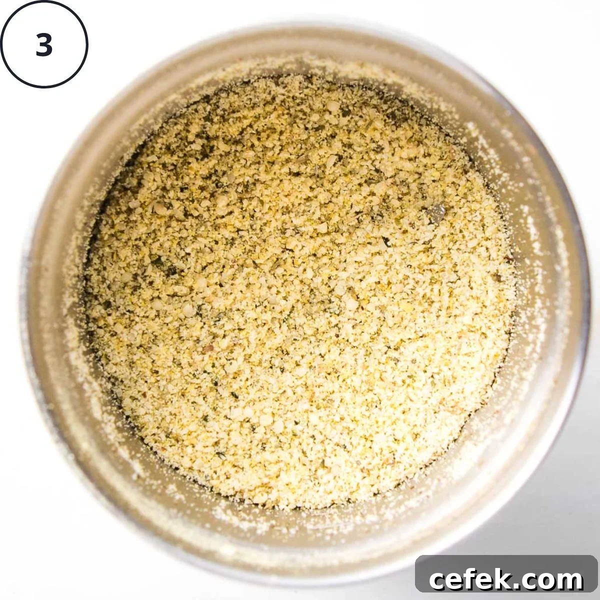 Vegan parmesan in a spice grinder, made with hemp seeds, nutritional yeast and spices ground together.