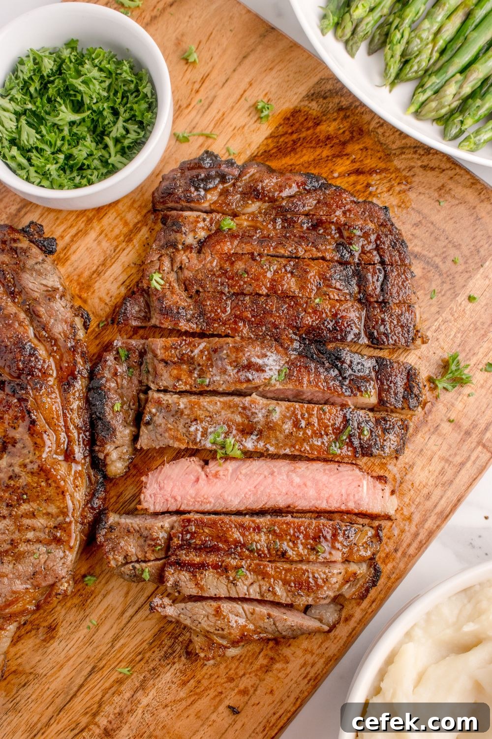 Grilled Ribeye Steaks sliced into strips showing a medium rare steak 