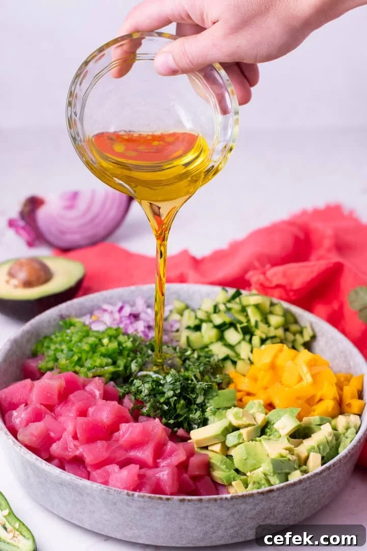 hand pouring olive oil into the mixture