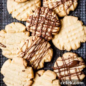 Mary Berry fork biscuits drizzled with chocolate on a baking tray.