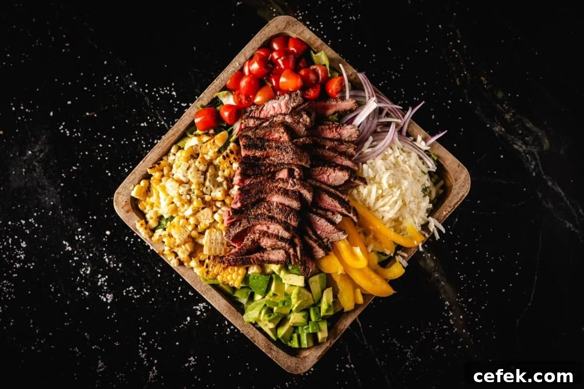 A wooden platter topped with sliced steak and veggies.