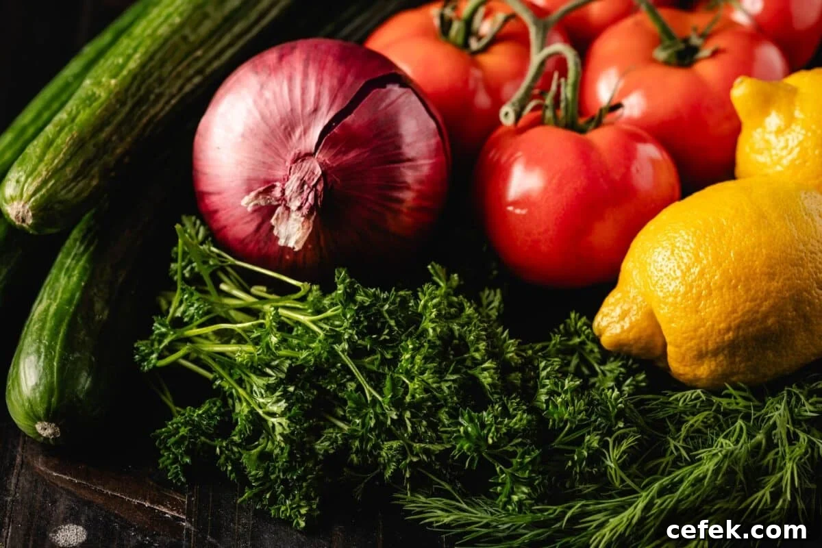 Fresh tomatoes, cucumbers, lemons, onion, and herbs.