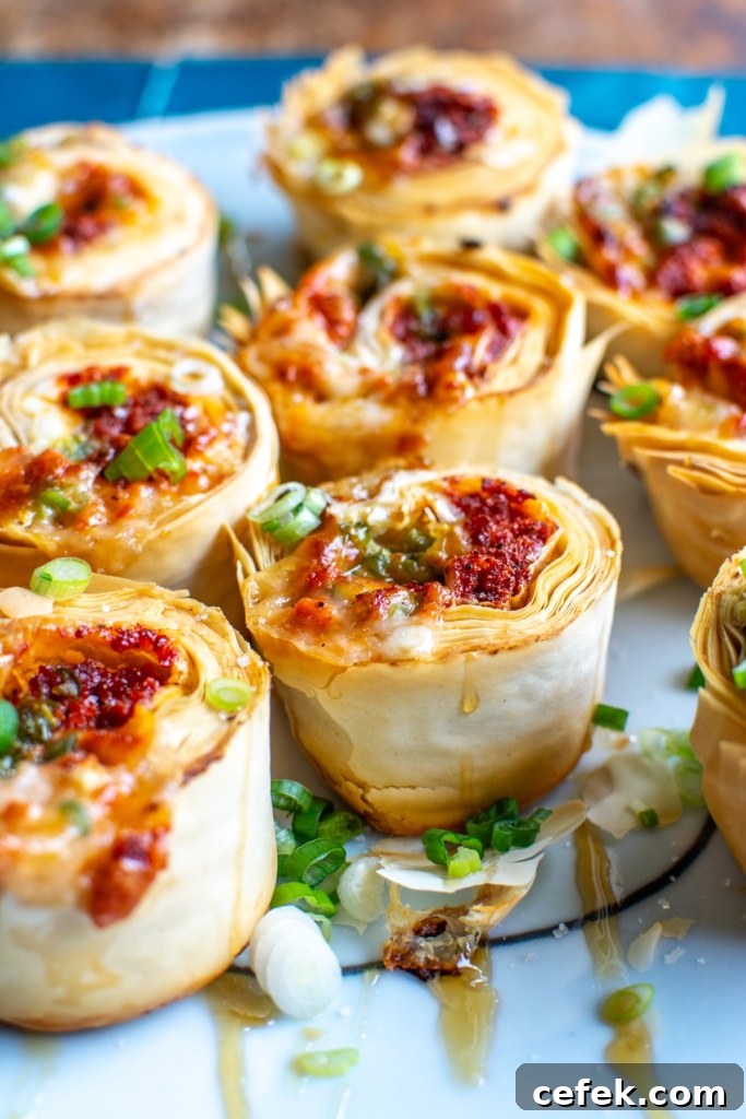The choriqueso pinwheel bites on a white platter