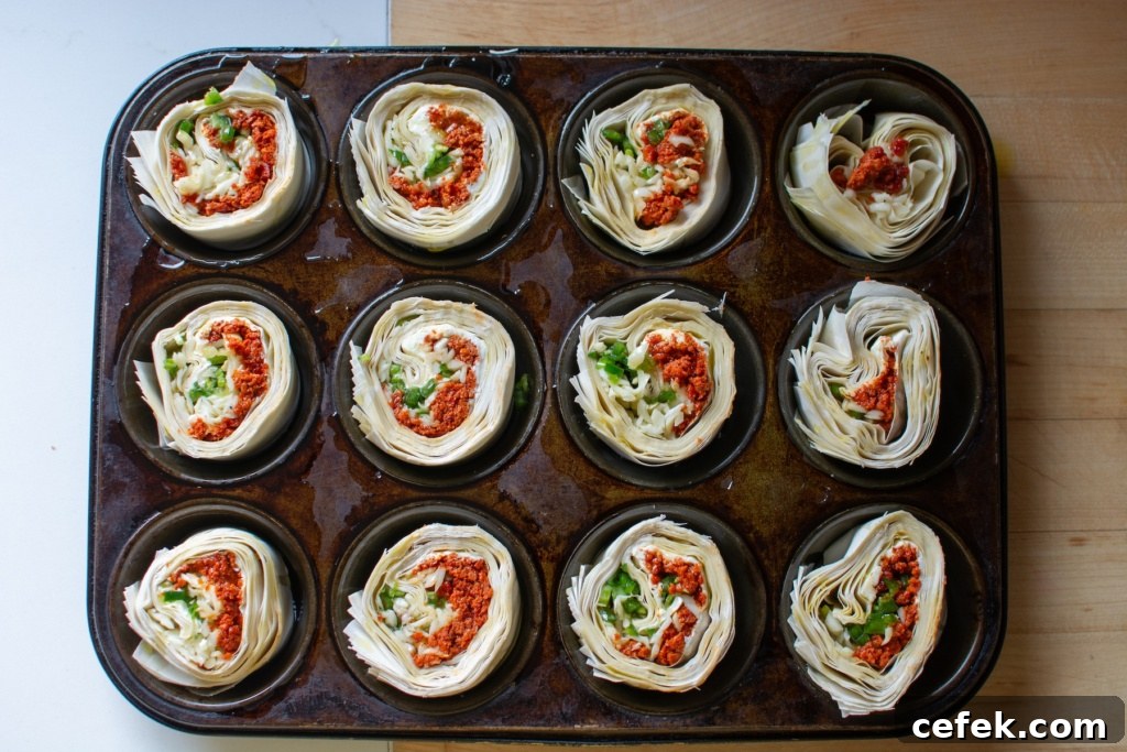 The pinwheels in a muffin tin before being baked
