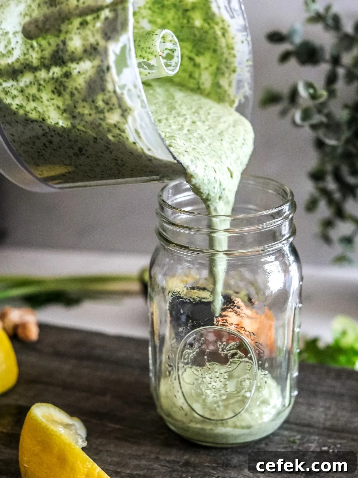 pouring green goddess dressing into mason jar