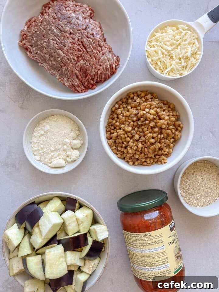 Ingredients for skillet eggplant parmesan casserole in bowls on a white kitchen counter