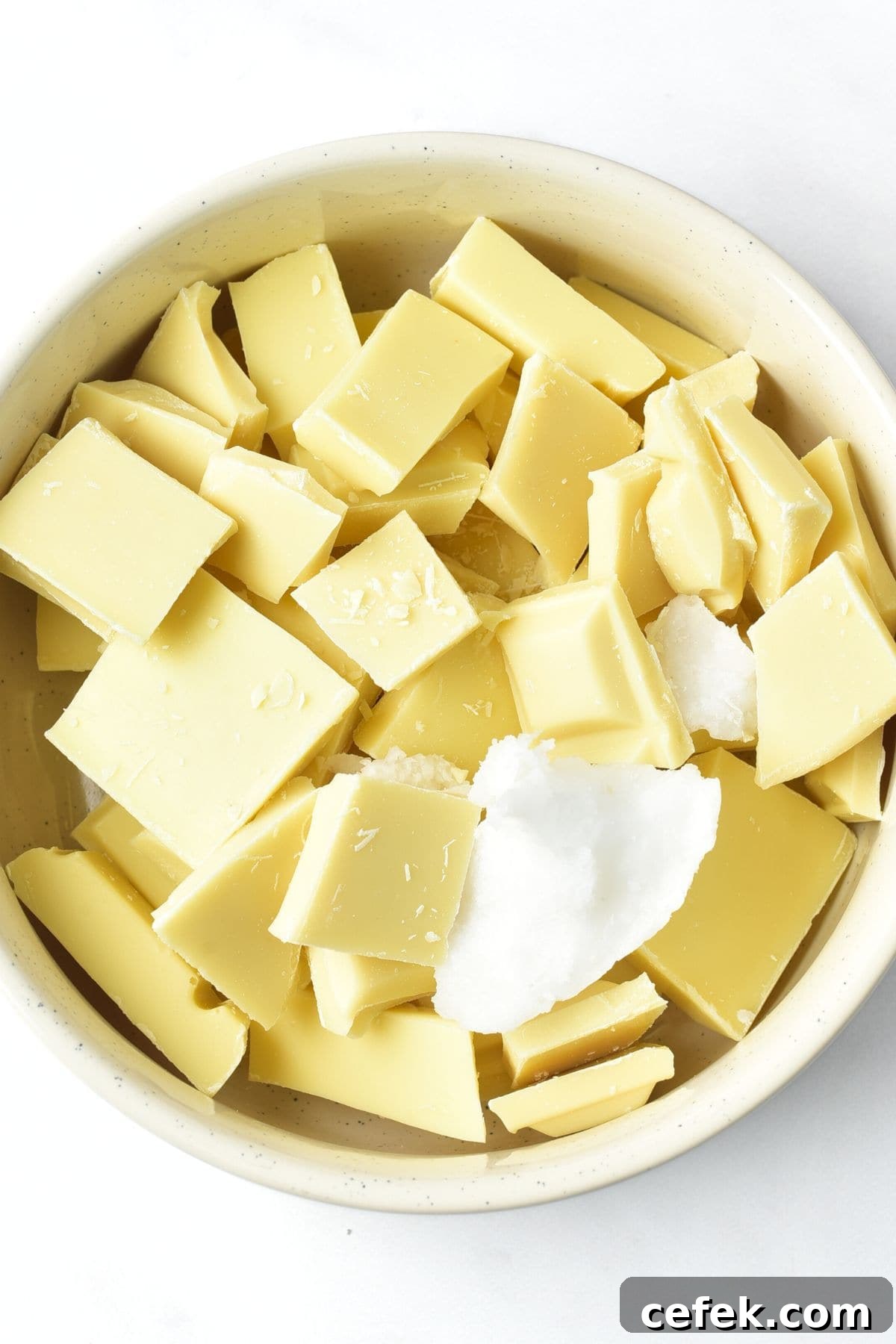 A bowl of white chocolate pieces and coconut oil