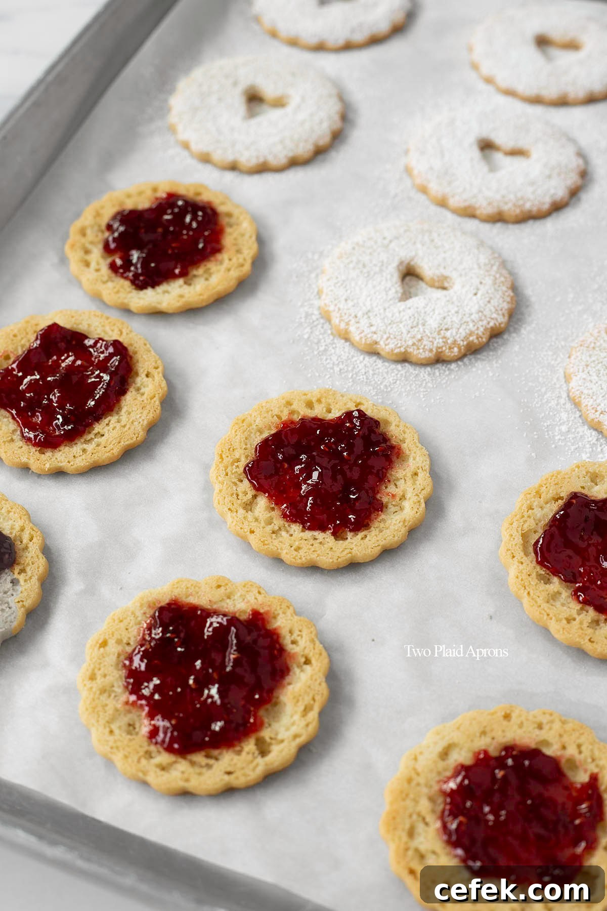 Linzer cookies with raspberry jam and powder sugar dusting.
