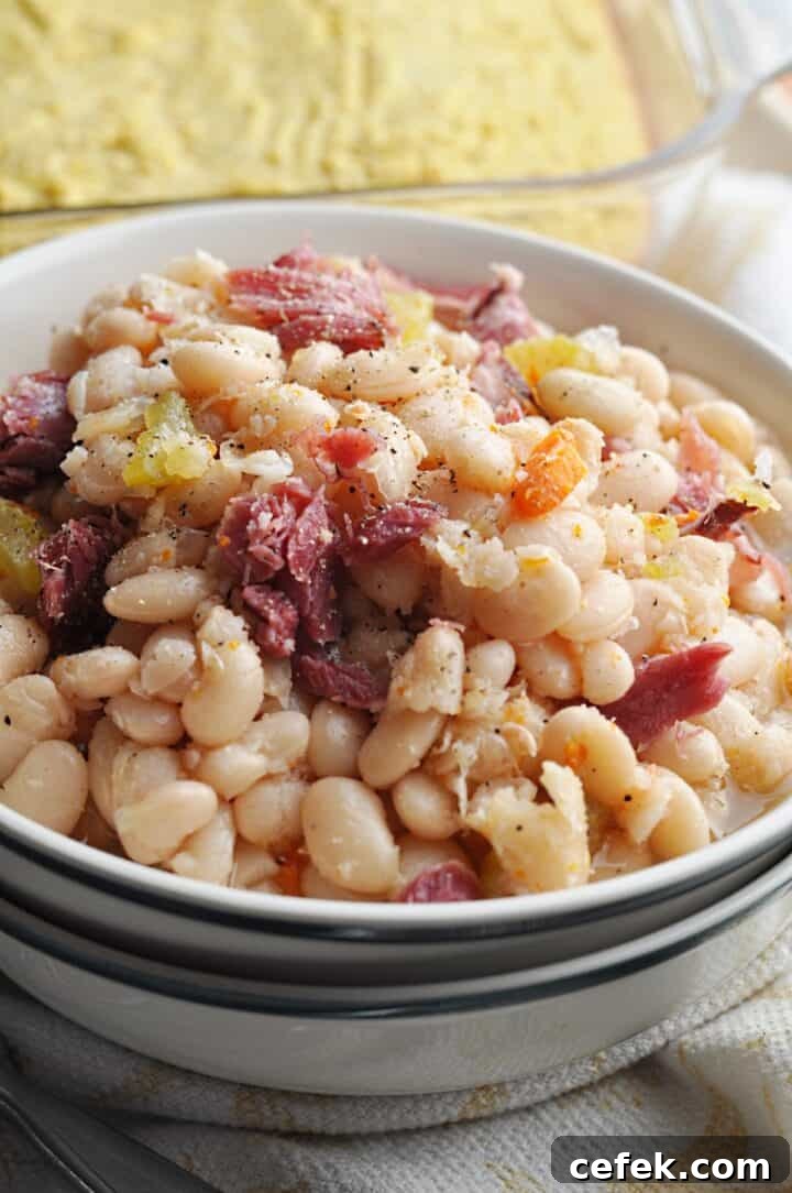 White beans with ham and carrots in bowl