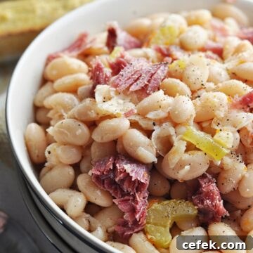 Great northern beans with ham close up in bowl