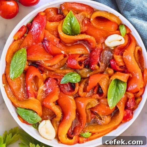 Roasted peppers marinated in a bowl.