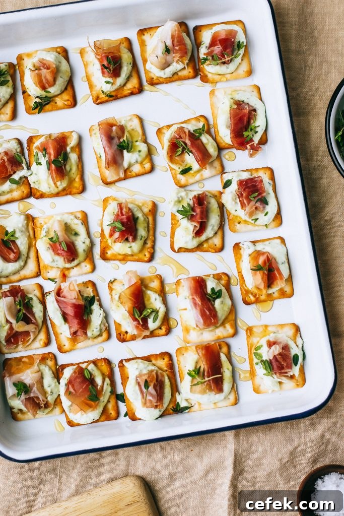 prosciutto and ricotta on crackers with honey drizzle on white tray on table cloth