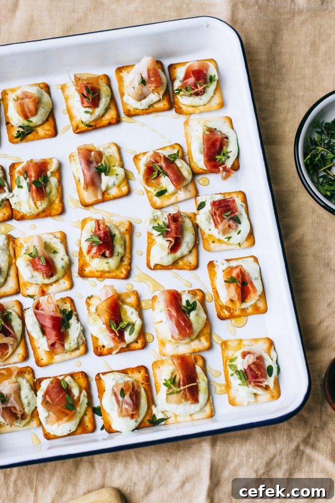 prosciutto and ricotta on crackers with honey drizzle on white tray on table cloth