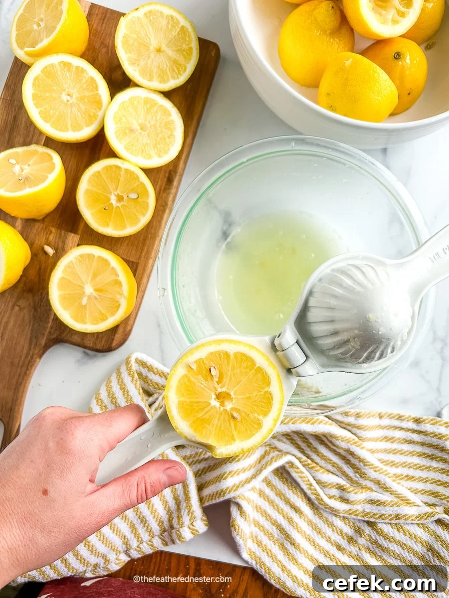 cutting board of cut citrus fruits next to a bowl full of lemon juice.