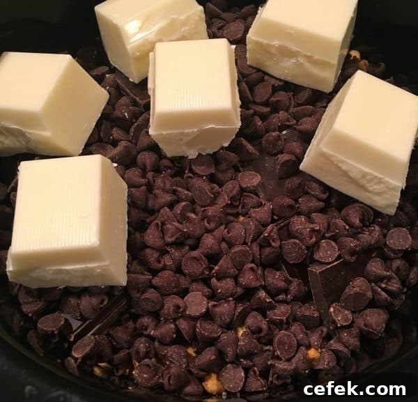 Almond bark added to slow cooker for peanut clusters