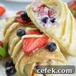 Two oven baked berry cheesecake chimichangas