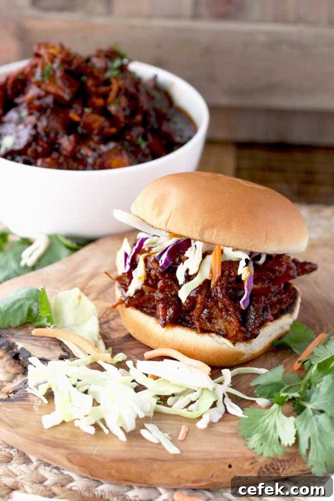 Pulled pork sandwich with coleslaw on a bun.