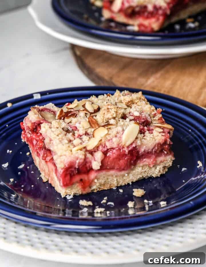 a blue plate with one gluten free strawberry rhubarb bar on it