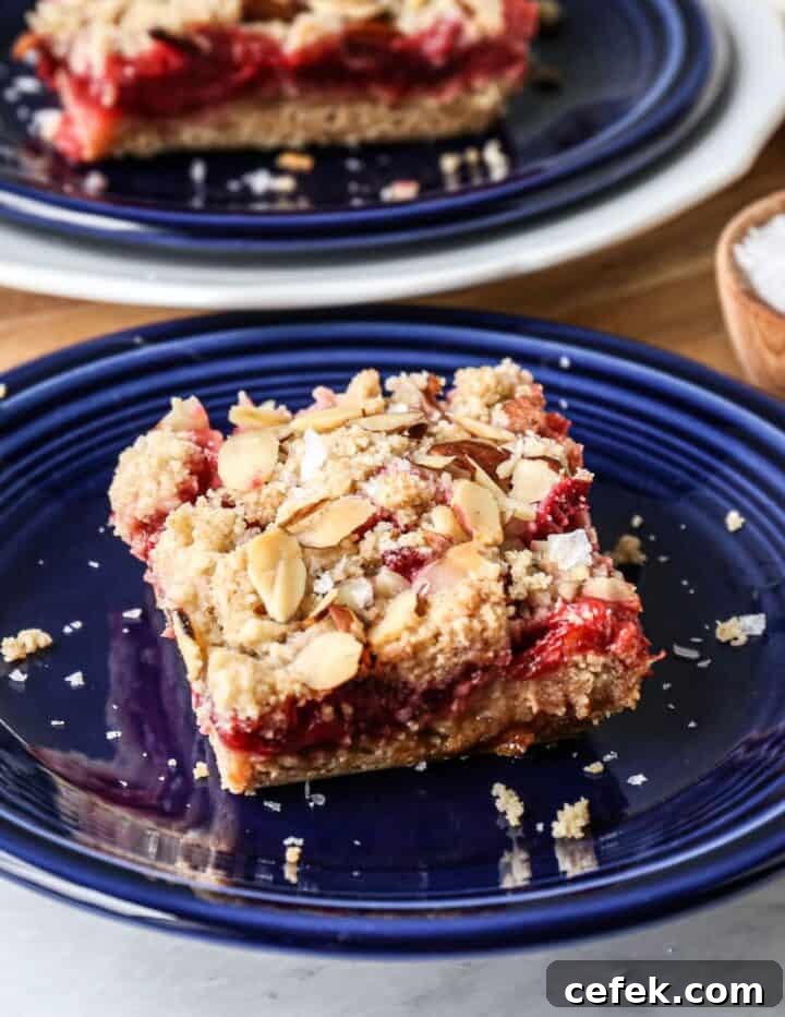 a blue plate with one gluten free strawberry rhubarb bar on it