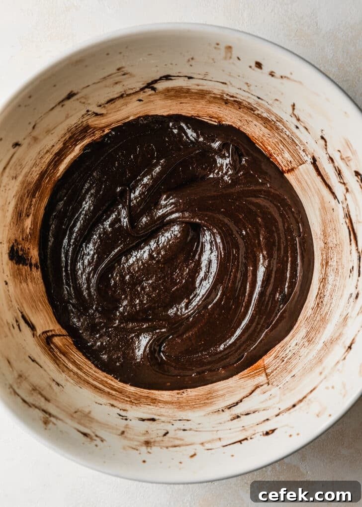 A white bowl of brownie bites batter.