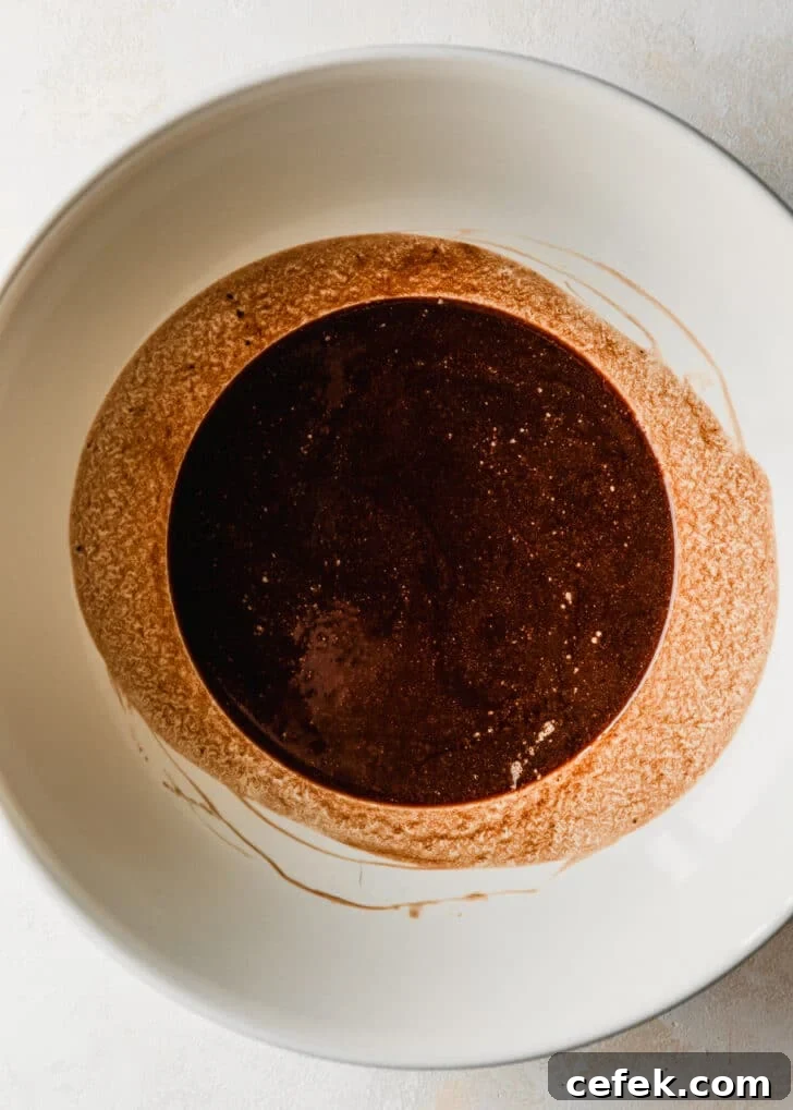 A white bowl of melted chocolate.