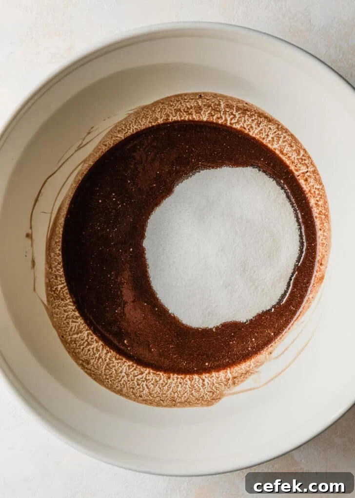 A white bowl of melted chocolate and sugar.