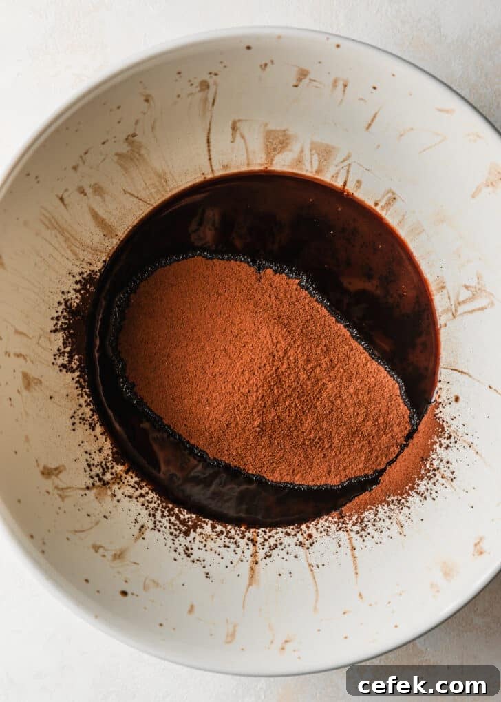 A white bowl of melted chocolate and cocoa powder.