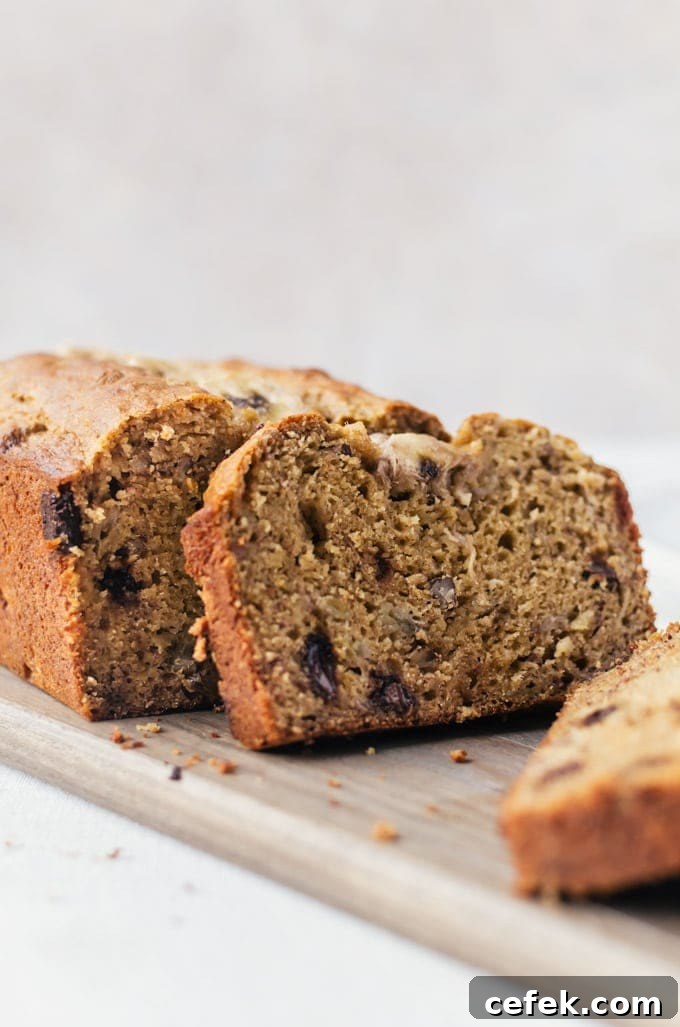 Close up of slices of whole wheat banana bread on wood cutting board