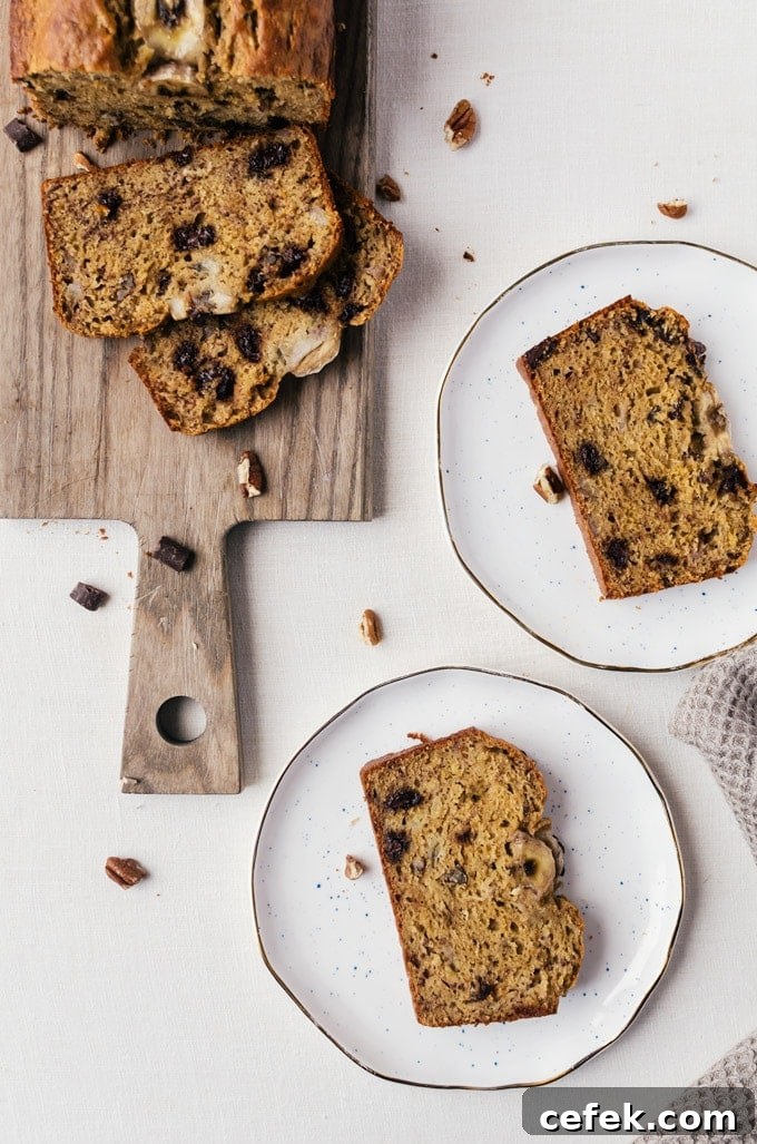 Banana bread on wood cutting board, slices of bread on plates