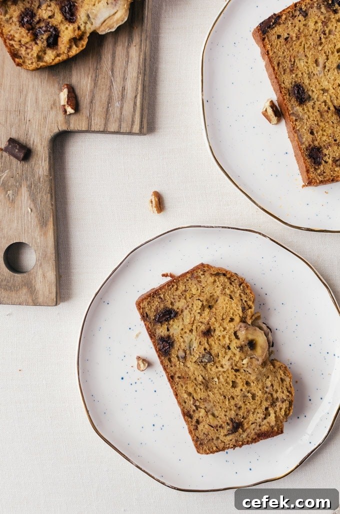 slice of whole wheat banana bread on white plate close up