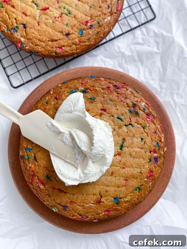 process shot of adding frosting to cake