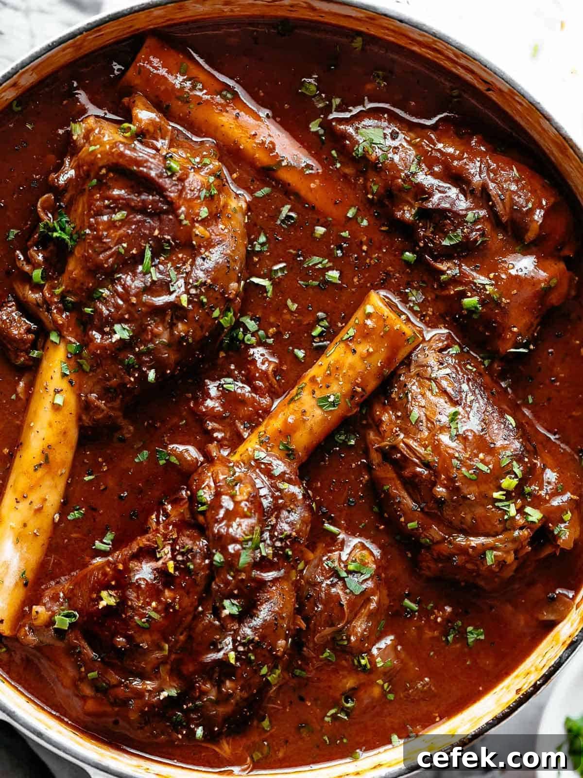 Tender, fall off the bone easy braised Lamb Shanks in a luxuriously delicious red wine gravy! Can be Cooked in Oven or stove top or slow cooker or Instant pot.
