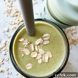 Spinach banana smoothies in toddler glass tumblers with silicone sleeves.