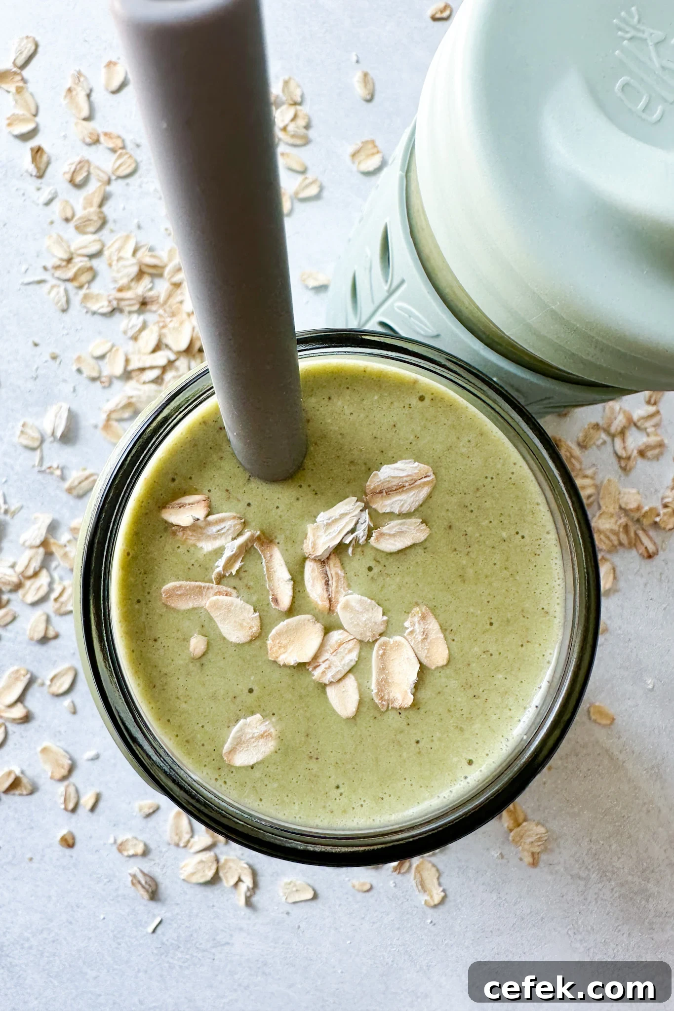 Spinach banana smoothies in toddler glass tumblers with silicone sleeves.