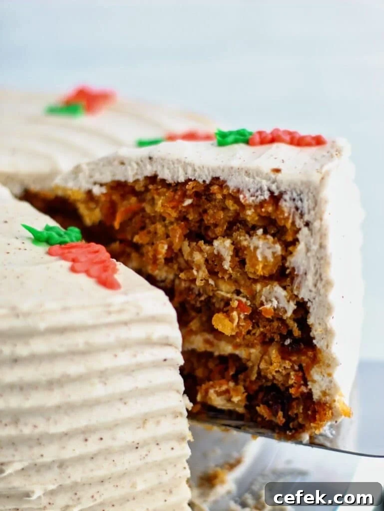 cutting out slice of gf carrot cake and holding it up on cake server.