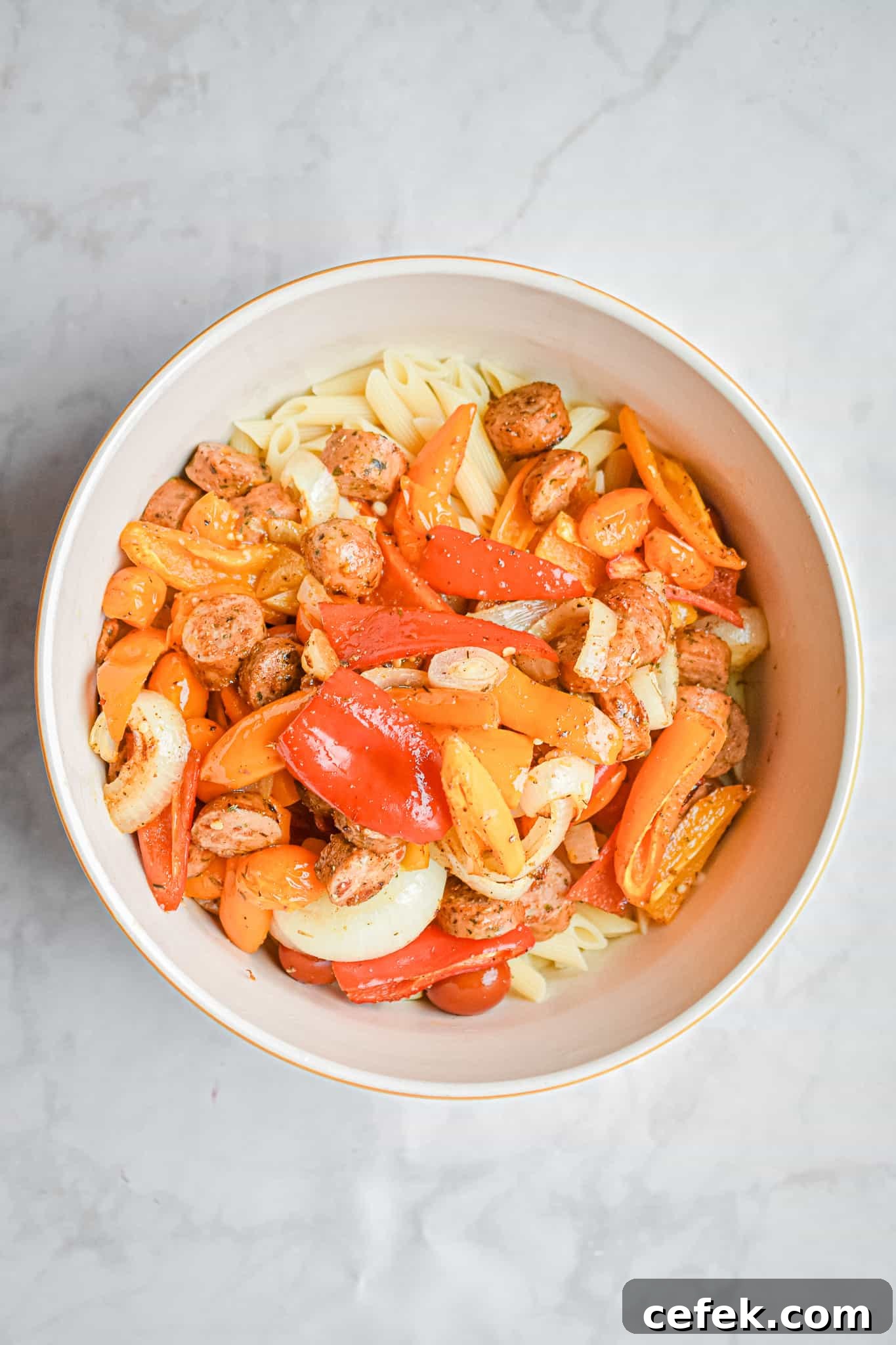 The chicken sausage and mini peppers are topping the pasta