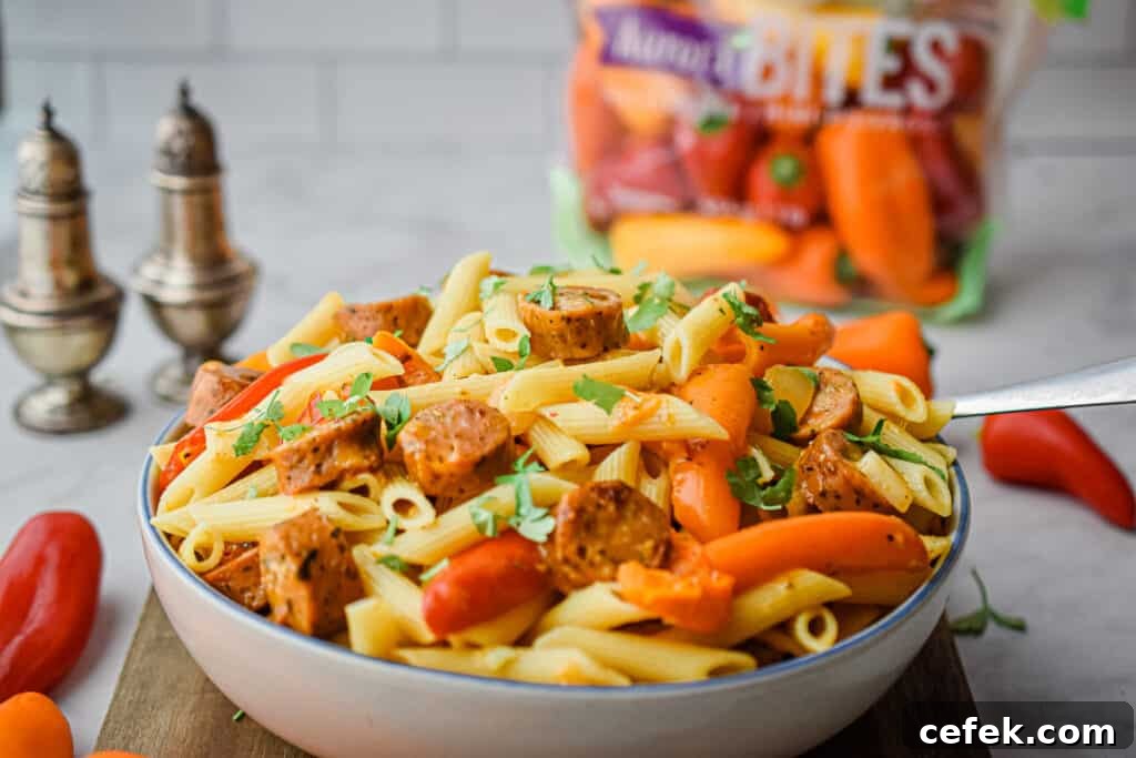 The chicken sausage and mini pepper pasta is horizontal with the bag of peppers in the background