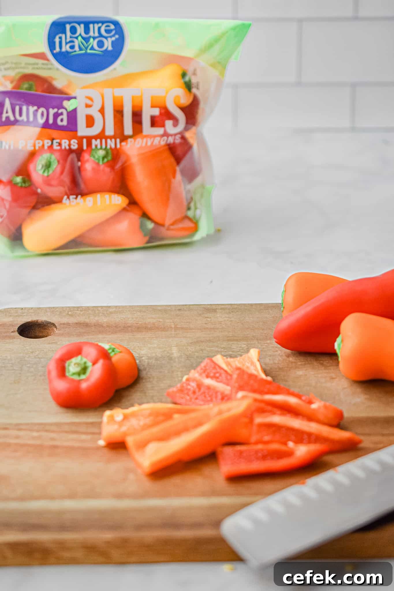 The peppers are being cut on a wooden cutting board