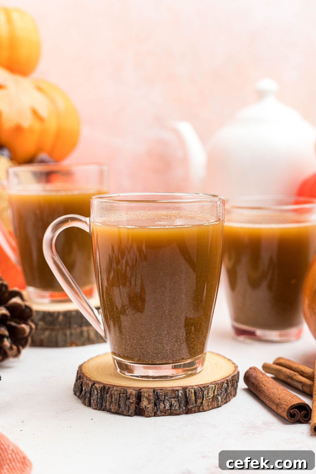 Clear glass of coffee mixed with pumpkin and spice mixture. 