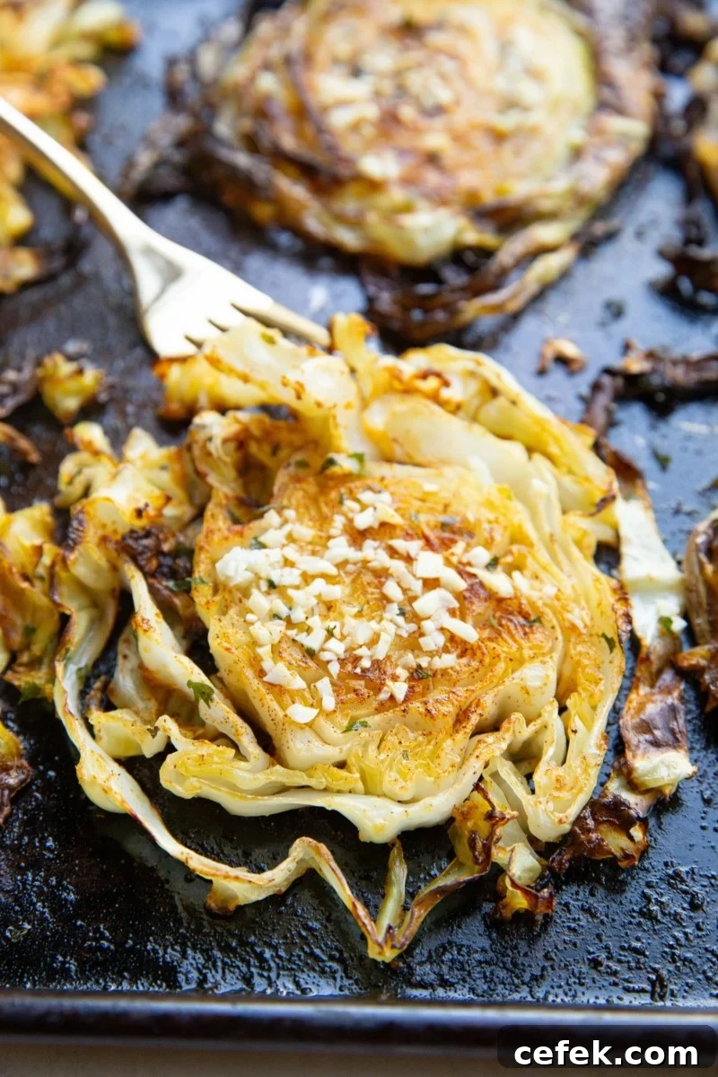 Finished cabbage fresh out of the oven with a fork, ready to eat.