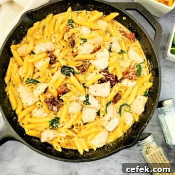 creamy tuscan chicken and pasta in skillet.