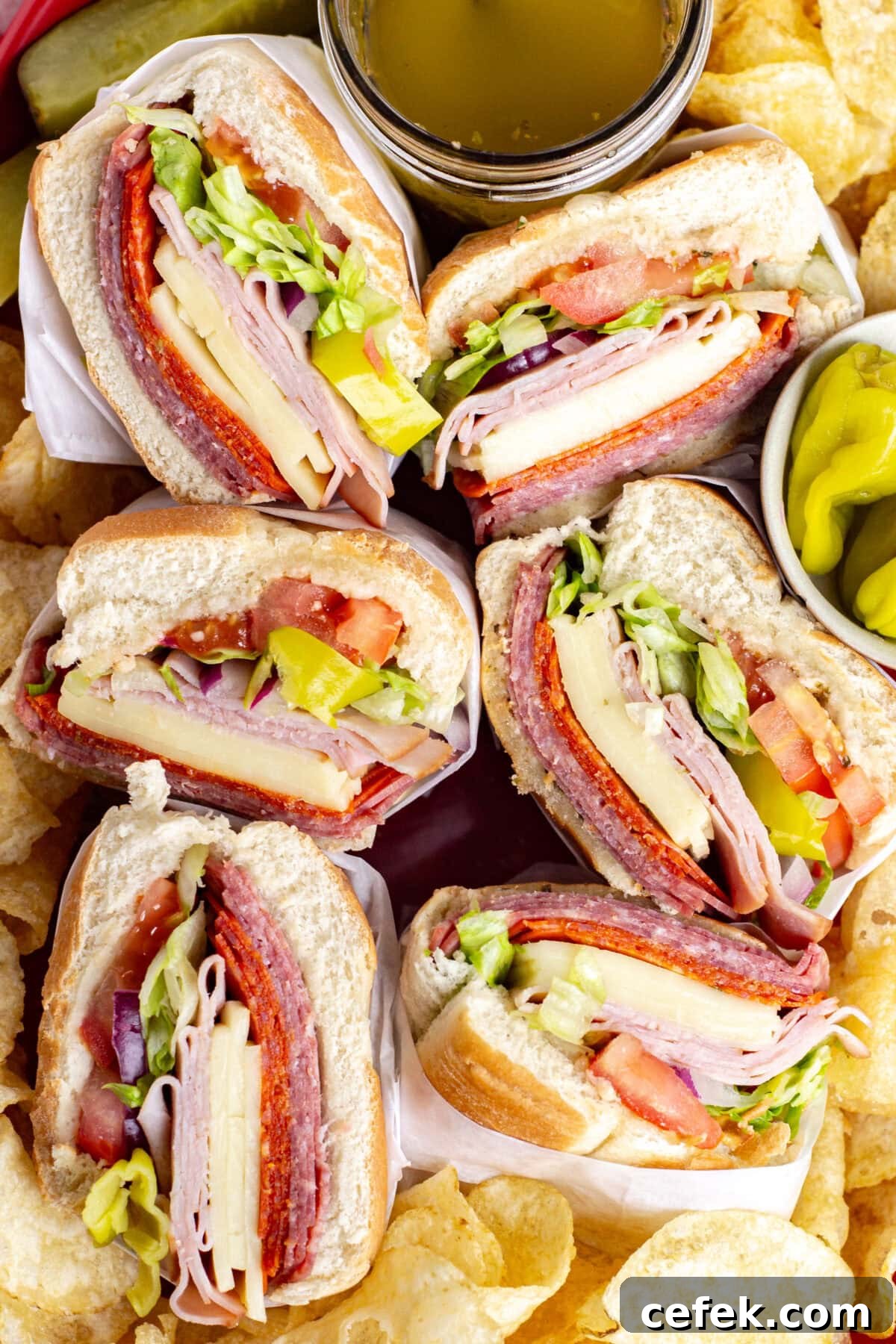 looking down on italian subs and potato chips on a platter